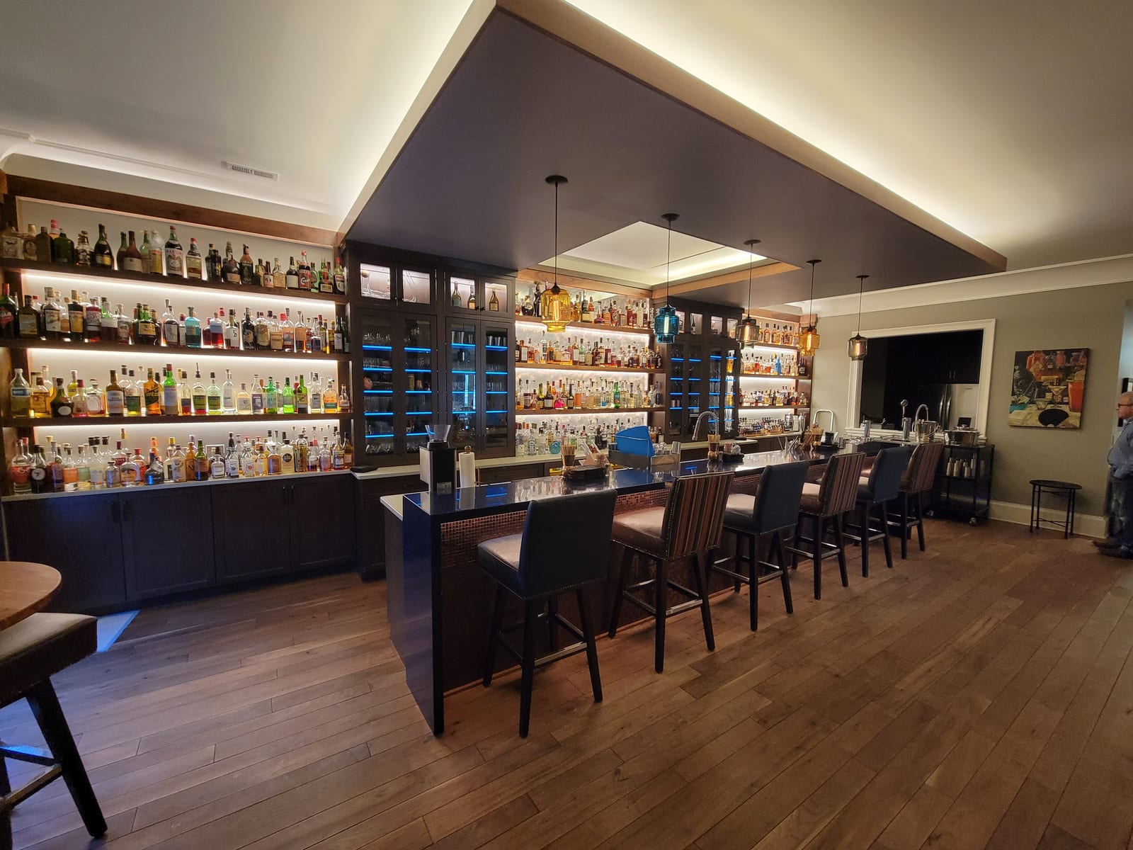 Custom curved-wood wine cellar with display lighting
